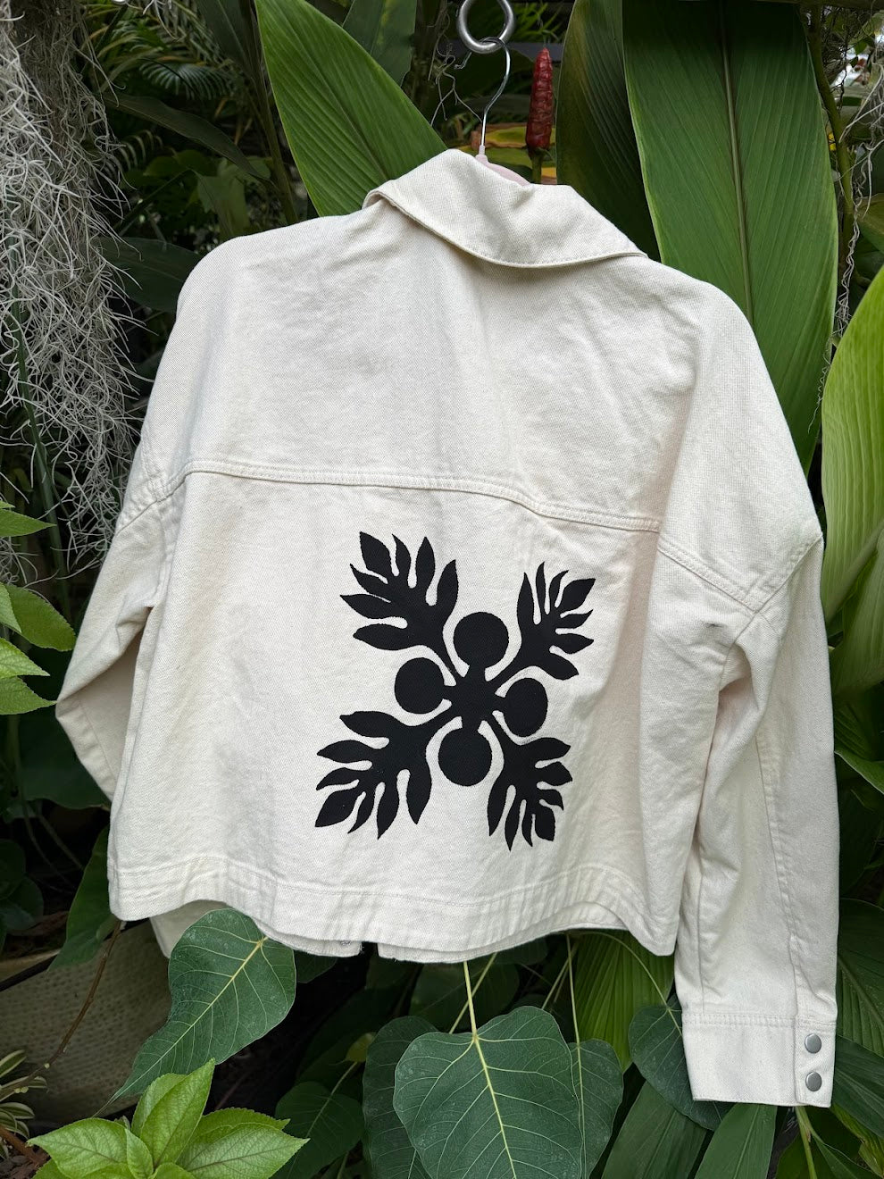White denim shirt with a black ulu design hand-painted by Culture Girl Boutique