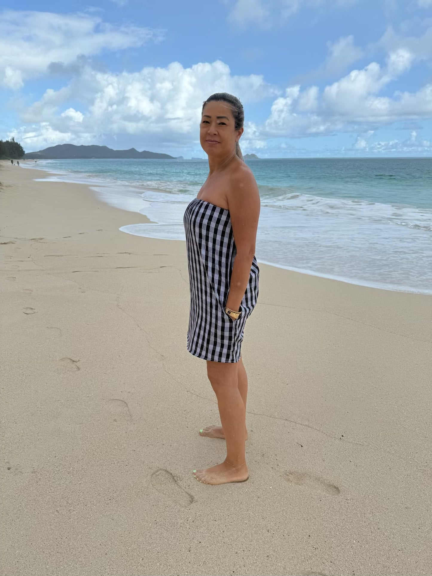 Side view of Culture Girl Boutique owner wearing black palaka strapless dress