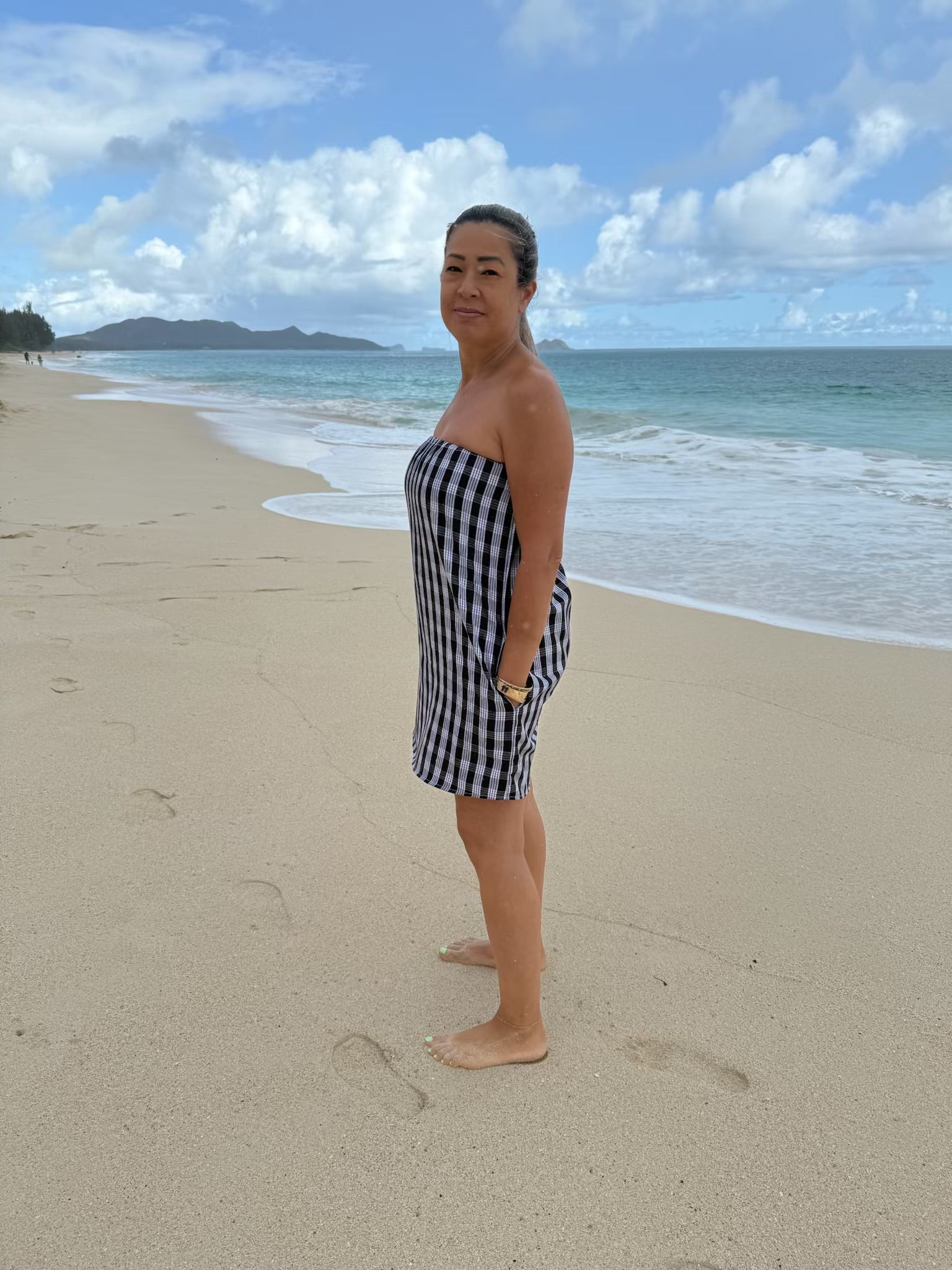 Side view of Culture Girl Boutique owner wearing black palaka strapless dress