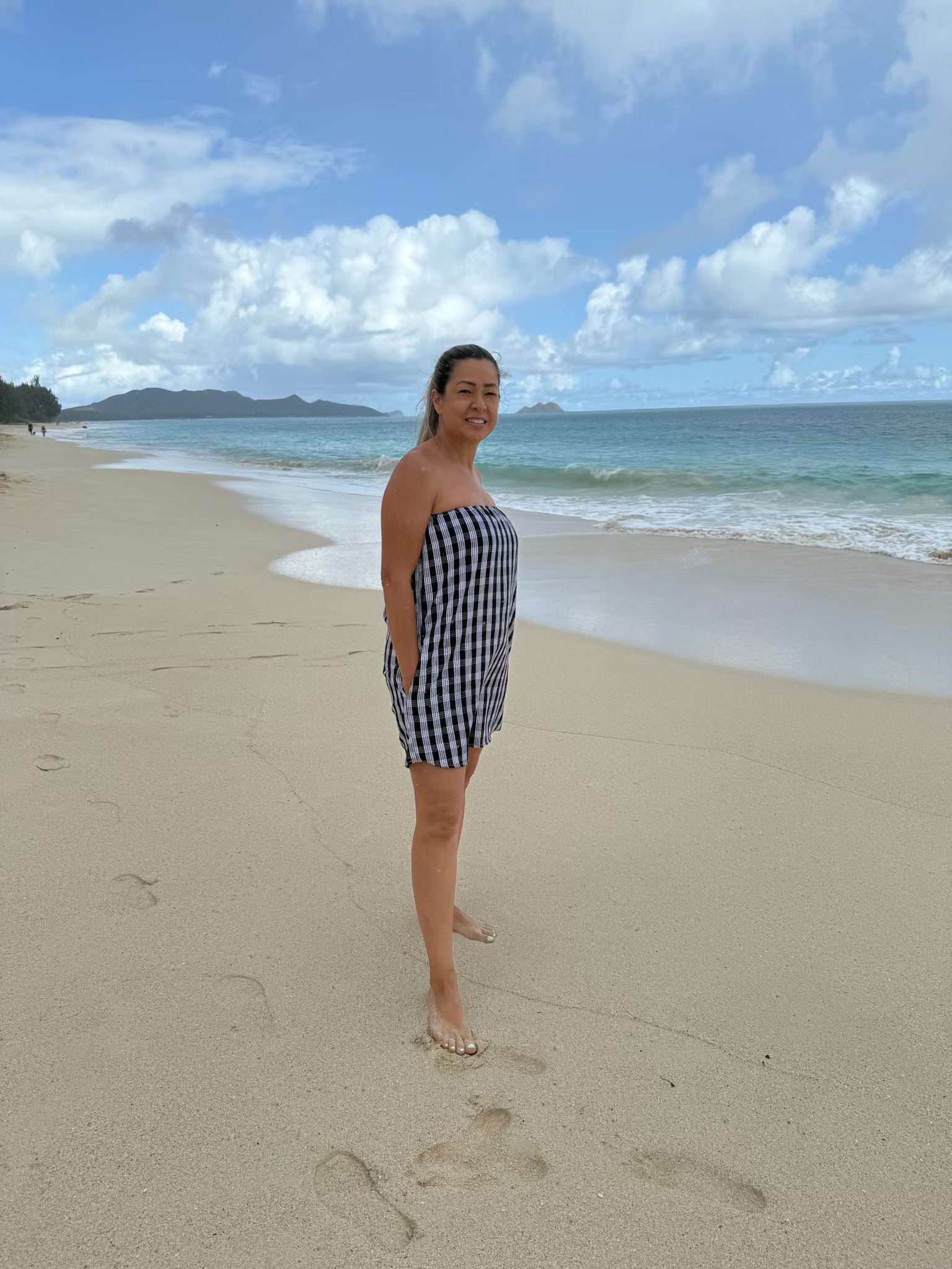 Side view of Culture Girl Boutique owner wearing black palaka strapless dress