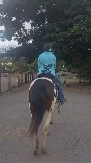 Model wearing Culture Girl light blue denim button down jacket with Hawaiian Ulu print design