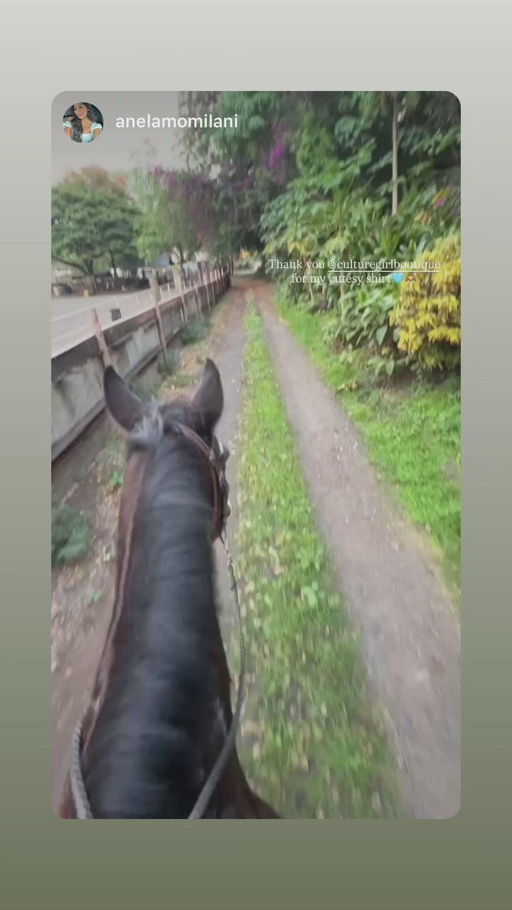 Model wearing Culture Girl light blue denim button down jacket with Hawaiian Ulu print design